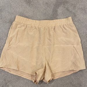 Stretchy beige gingham shorts from Aritzia